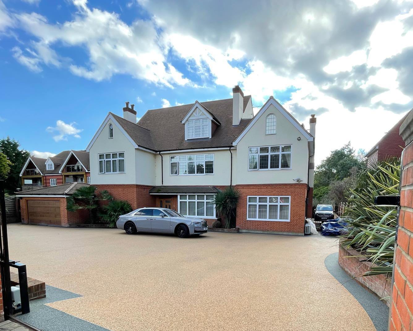 large 3 story detatched house with resin driveway and car